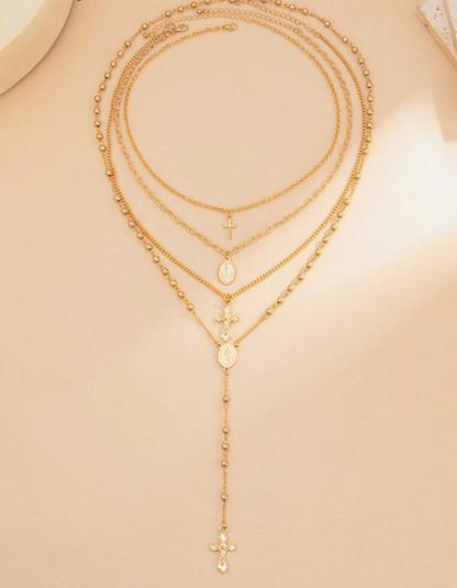 Áurea | Set de 4 collares dorados con cruces y medallas.